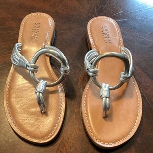 Flat sandals with silver ornamentation.